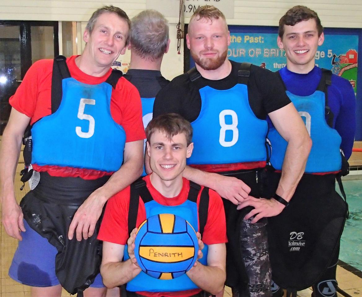 Four paddlers in blue buoyancy aids posing with a ball marked Penrith.